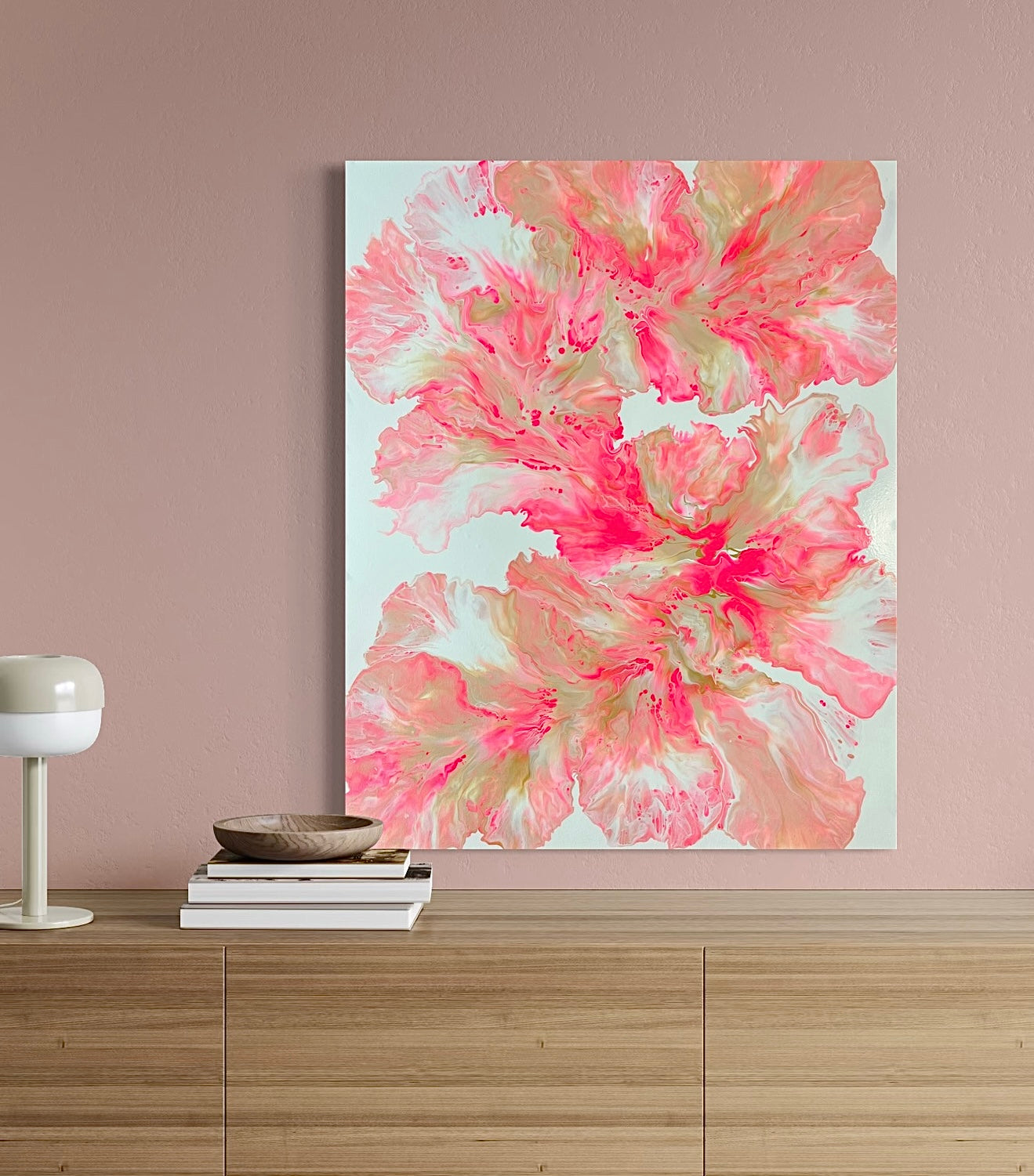 Abstract acrylic painting in bright shades of pink, red, and gold on a white background. The flowing, flower-like shapes are reminiscent of organic leaves or petals and create a lively, harmonious movement. Modern wall art with a feminine and elegant expression, perfect for contemporary interiors.