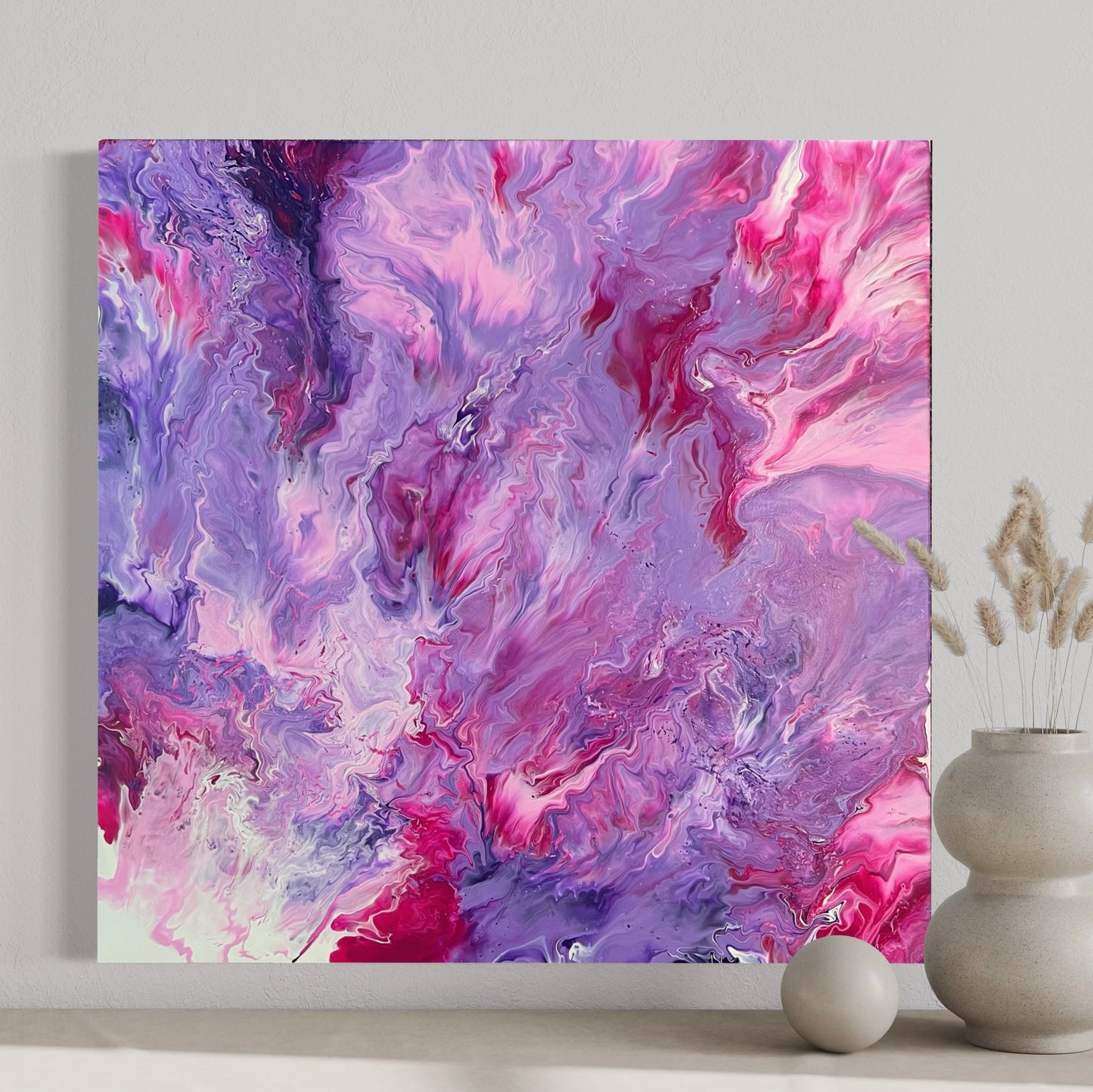 Abstract acrylic painting in intense shades of pink, purple, and violet with soft, flowing color gradients and a dynamic depth effect. The harmonious composition is reminiscent of clouds, flowers, or movement in water and creates an atmosphere that is both powerful and calming. Hand-painted, one-of-a-kind piece in the fluid art style—modern abstract art on canvas, ideal as an elegant eye-catcher in contemporary interior design.