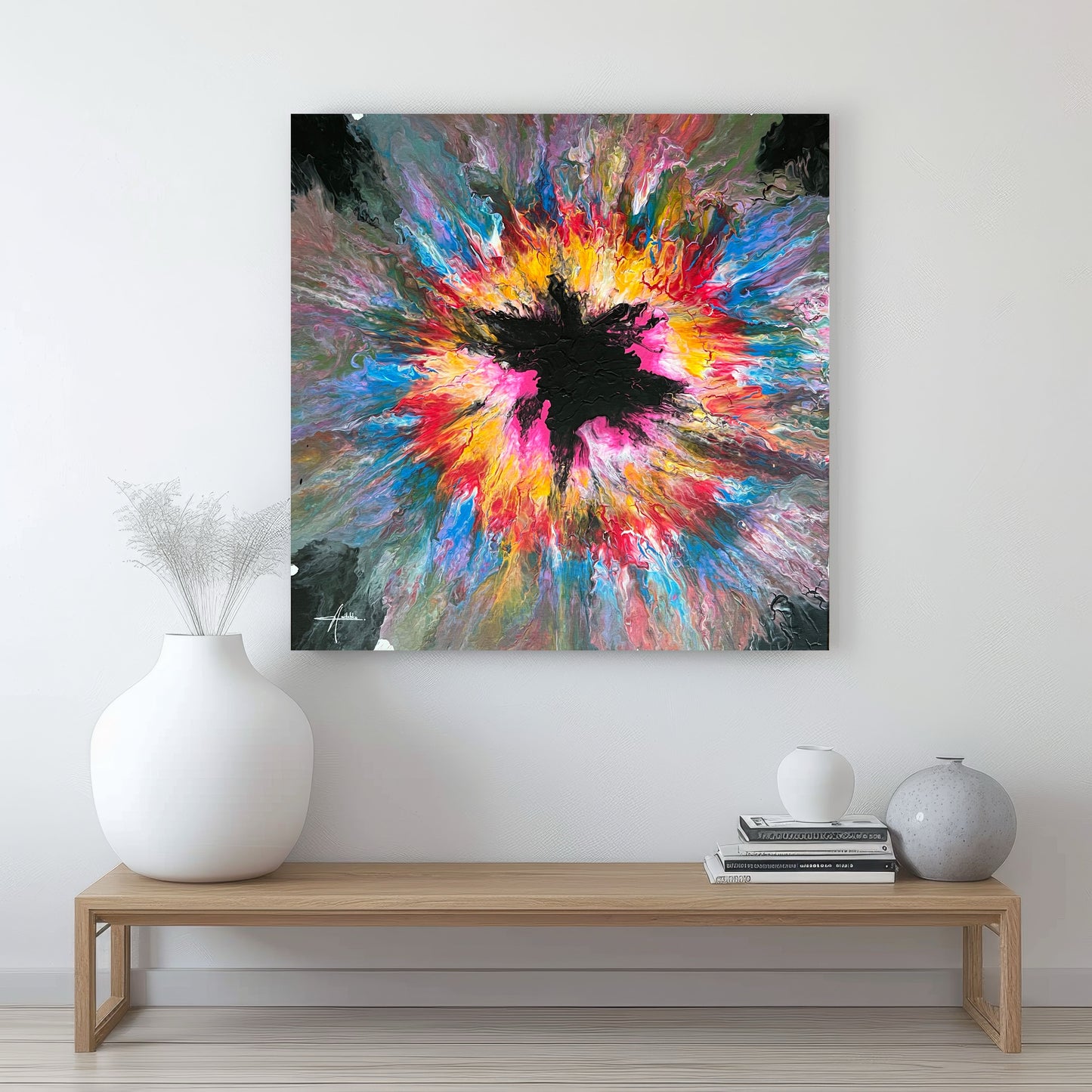 Abstract acrylic painting with an explosive burst of color in yellow, pink, blue and red on a black background - modern fluid art artwork with a central black element and powerful energy.