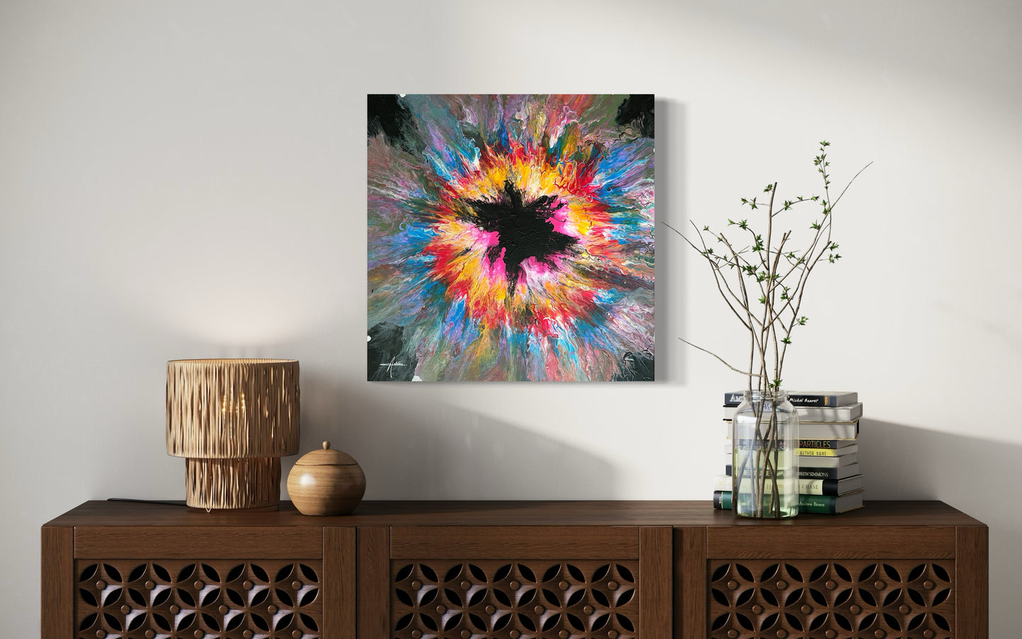 Abstract acrylic painting with an explosive burst of color in yellow, pink, blue and red on a black background - modern fluid art artwork with a central black element and powerful energy.