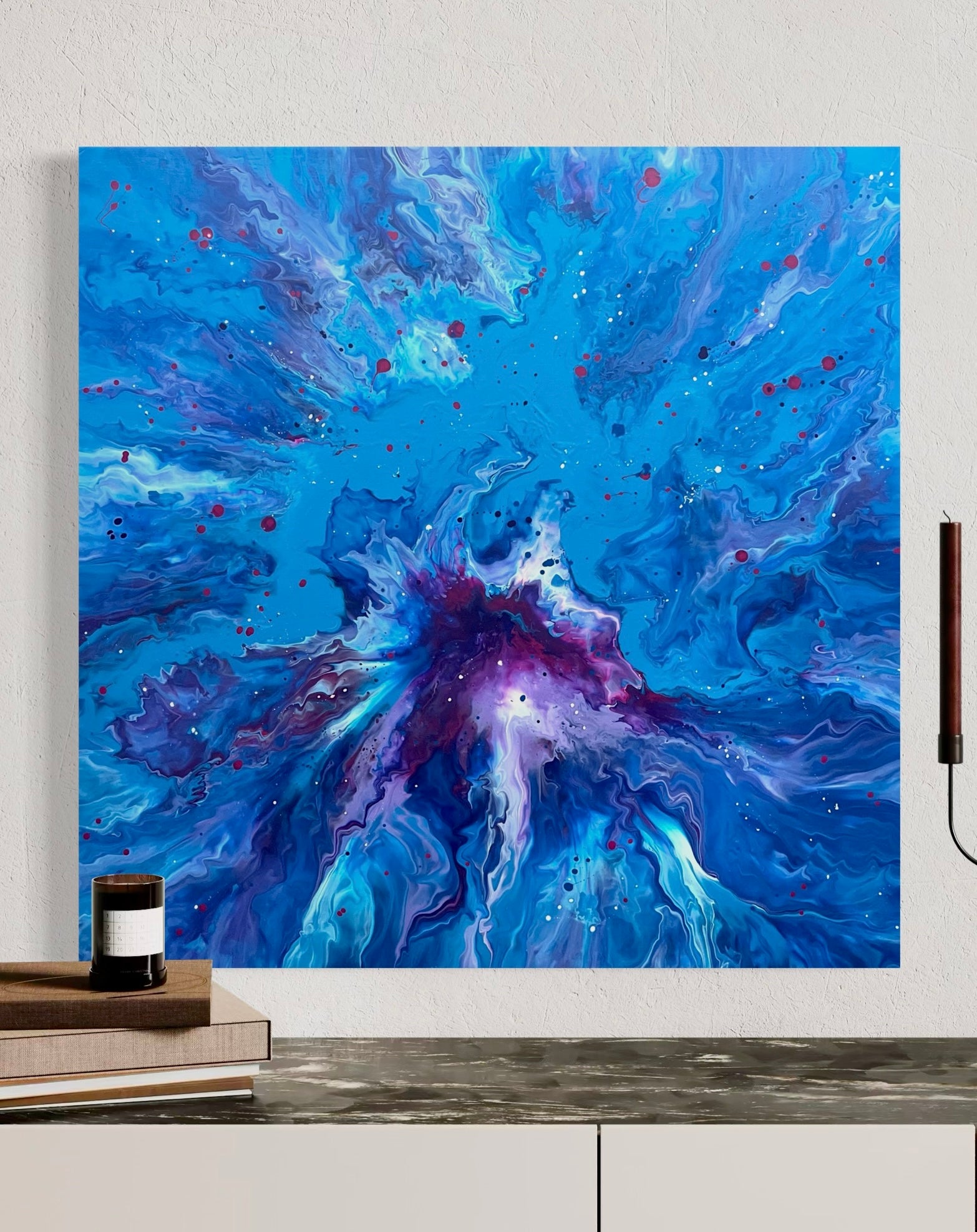 Abstract acrylic painting in intense shades of blue with a violet center, dynamic flowing structures and colorful speckles - modern fluid art artwork with a cosmic effect on a blue background.