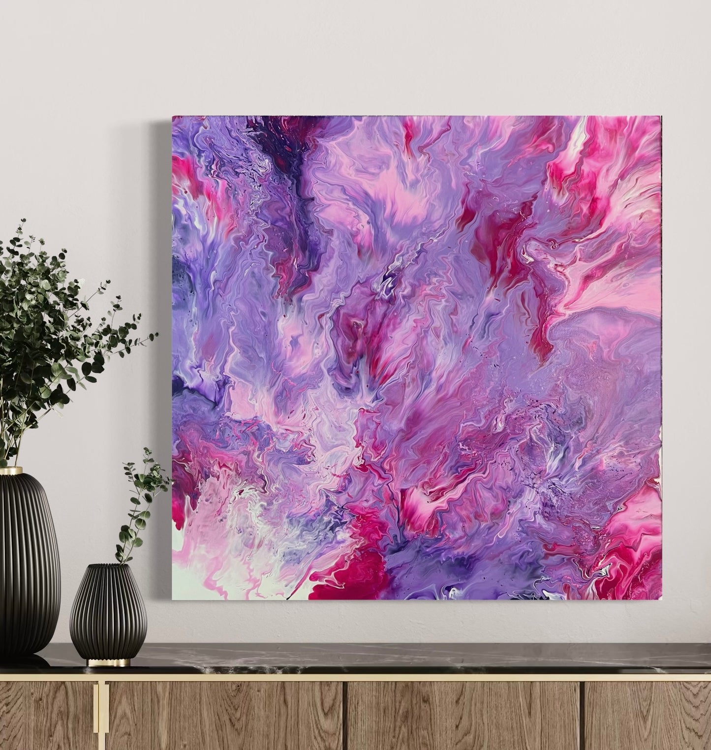 Abstract acrylic painting in intense shades of pink, purple, and violet with soft, flowing color gradients and a dynamic depth effect. The harmonious composition is reminiscent of clouds, flowers, or movement in water and creates an atmosphere that is both powerful and calming. Hand-painted, one-of-a-kind piece in the fluid art style—modern abstract art on canvas, ideal as an elegant eye-catcher in contemporary interior design.