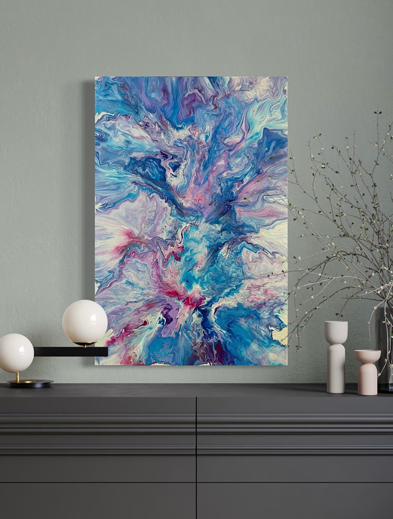 Expressive acrylic painting with marbled structures in shades of blue, turquoise, purple and pink on canvas - abstract wall art in a modern living style with fluid art technique.