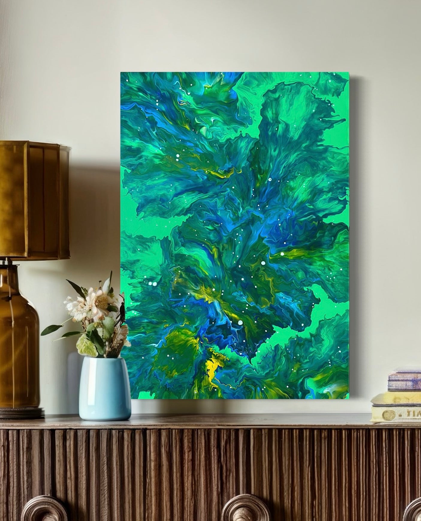 Abstract acrylic painting in bright green, blue and yellow with flowing textures and white accents - modern fluid art artwork as a natural color accent for contemporary living spaces.