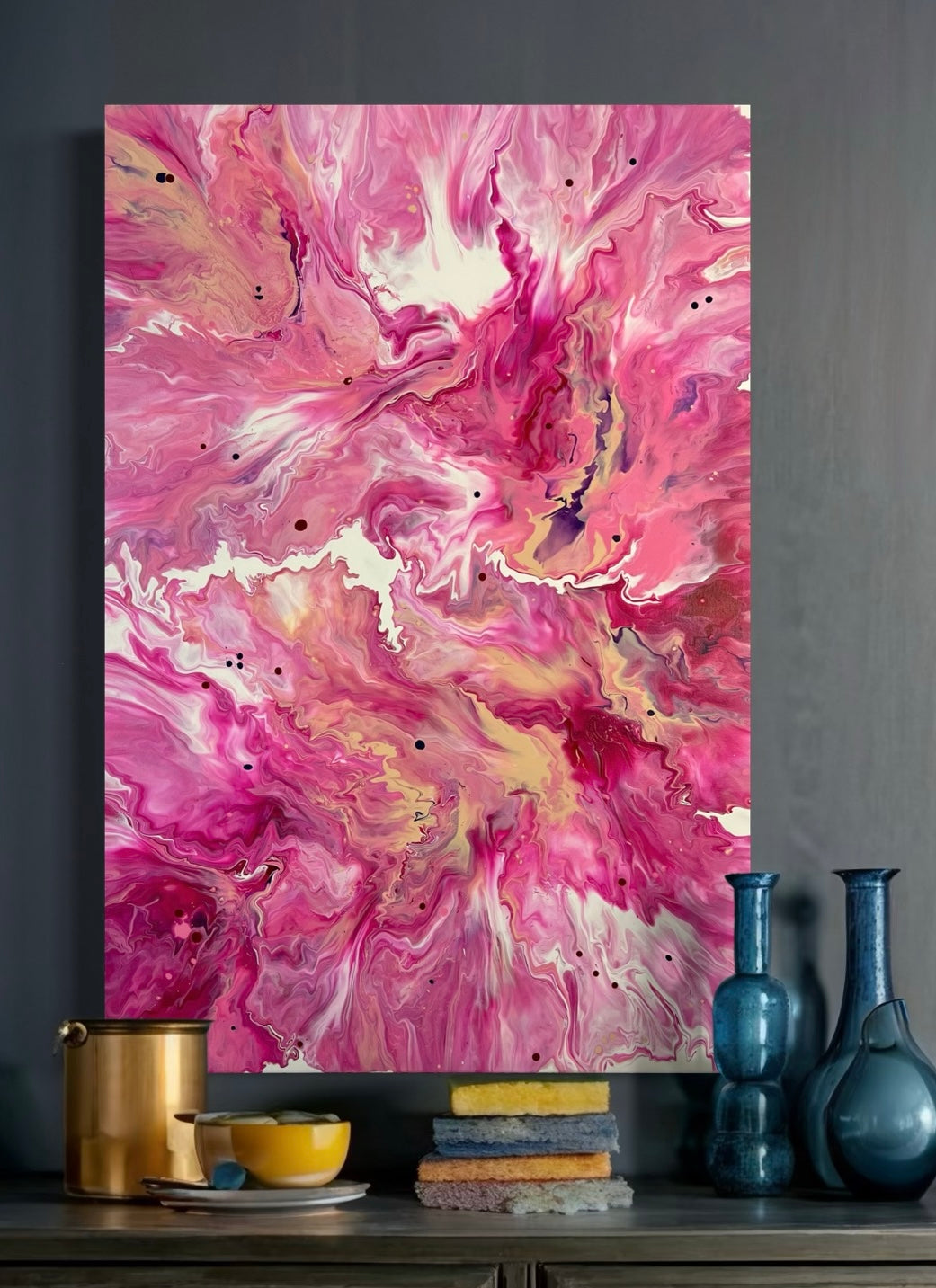 Abstract acrylic painting in intense shades of pink, fuchsia, and violet with soft color gradients and golden yellow accents. The flowing structures are reminiscent of blossoming flowers or cloud movements and create a lively, feminine, and harmonious mood. Hand-painted, one-of-a-kind piece in the fluid art style—modern abstract art on canvas, ideal as an eye-catcher for contemporary living spaces.