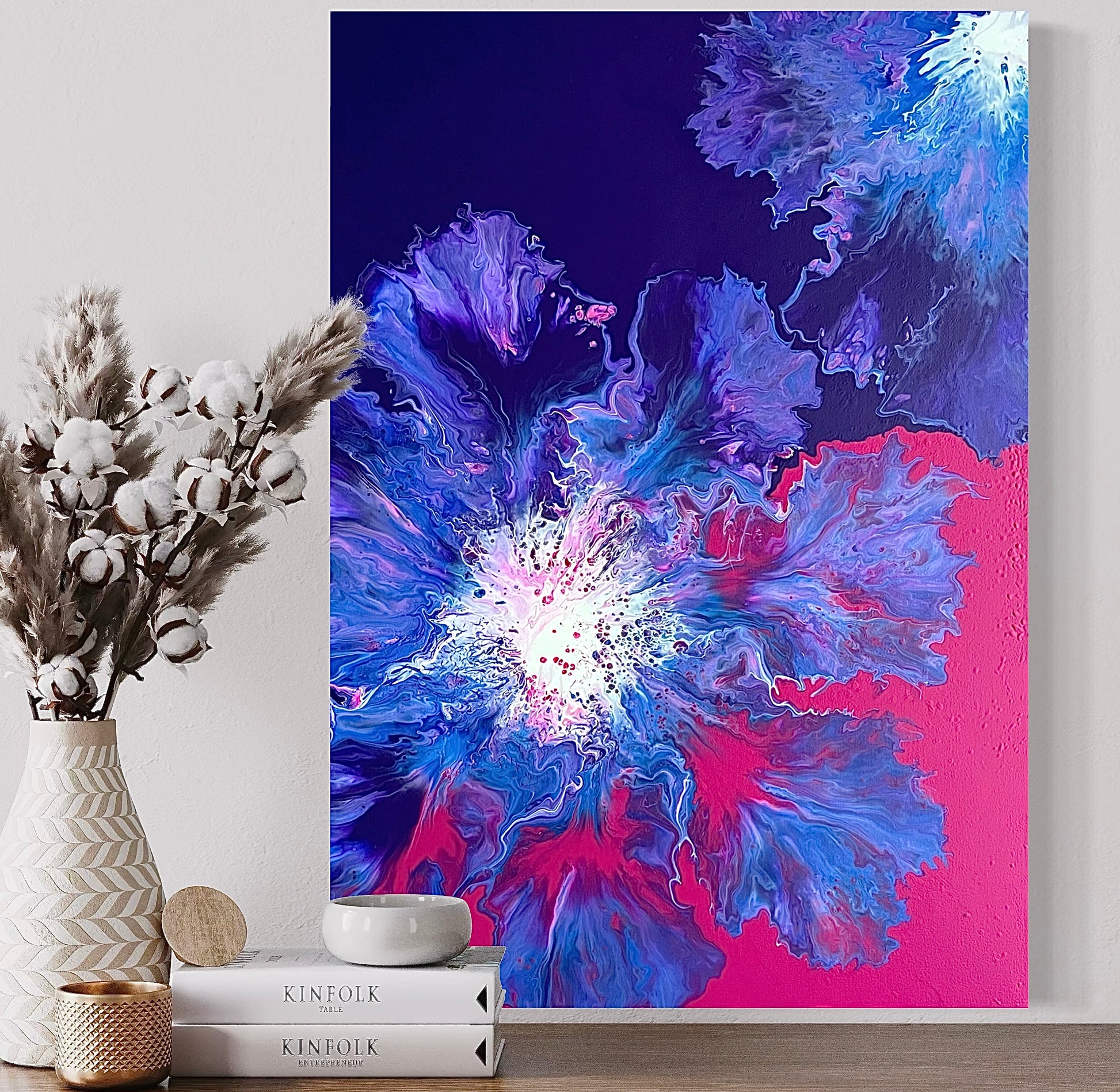 Abstract acrylic painting with strong flowing structures in purple, pink, blue and white on a purple-pink background - modern fluid art artwork with a luminous center and energetic color gradient.