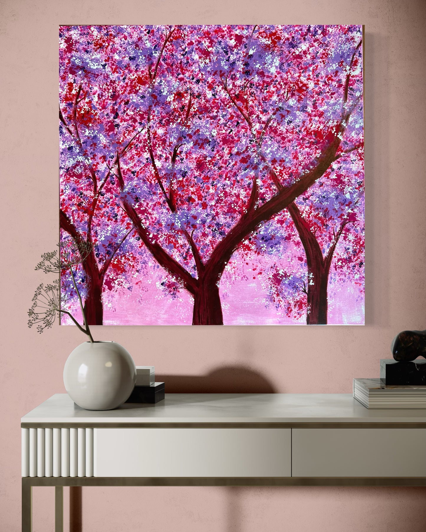 Colorful acrylic painting with blossoming trees in purple, pink and red tones on a pink background - impressionistic depiction of a spring forest with strong tree trunks and lively leaf structure.
