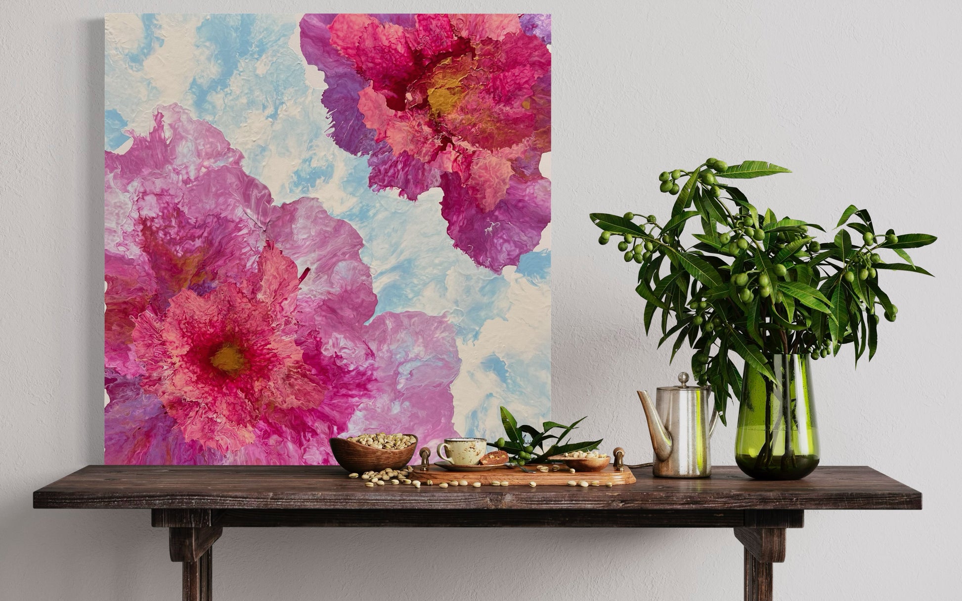 Acrylic painting featuring large, abstract flowers in bright shades of pink, rose, and violet on a light, sky-blue background. The delicate flower shapes appear lively and dynamic, with gentle color gradients and fine structures that create depth and movement. Hand-painted, one-of-a-kind piece in the modern floral art style—modern floral art on canvas that radiates freshness, lightness, and joie de vivre.