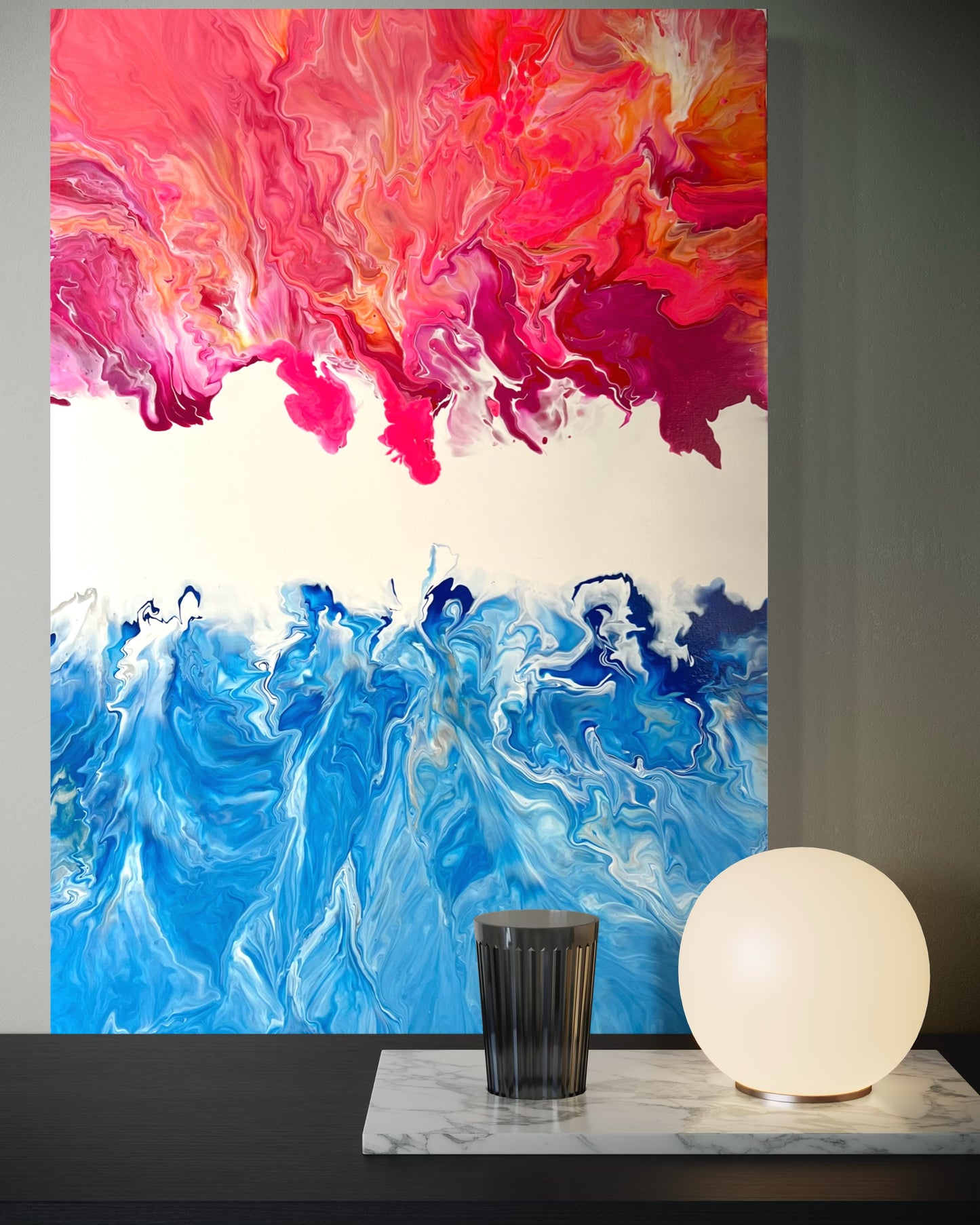 Abstract acrylic painting in vibrant shades of blue, pink, and orange, combining the dynamism of fire and water in flowing forms. The upper half of the painting features warm, fiery color gradients, while the lower blue tones are reminiscent of waves or ocean movements. Hand-painted, one-of-a-kind piece in the fluid art style—modern abstract art on canvas with strong expressiveness and harmonious color contrast, ideal as an eye-catcher in contemporary spaces.