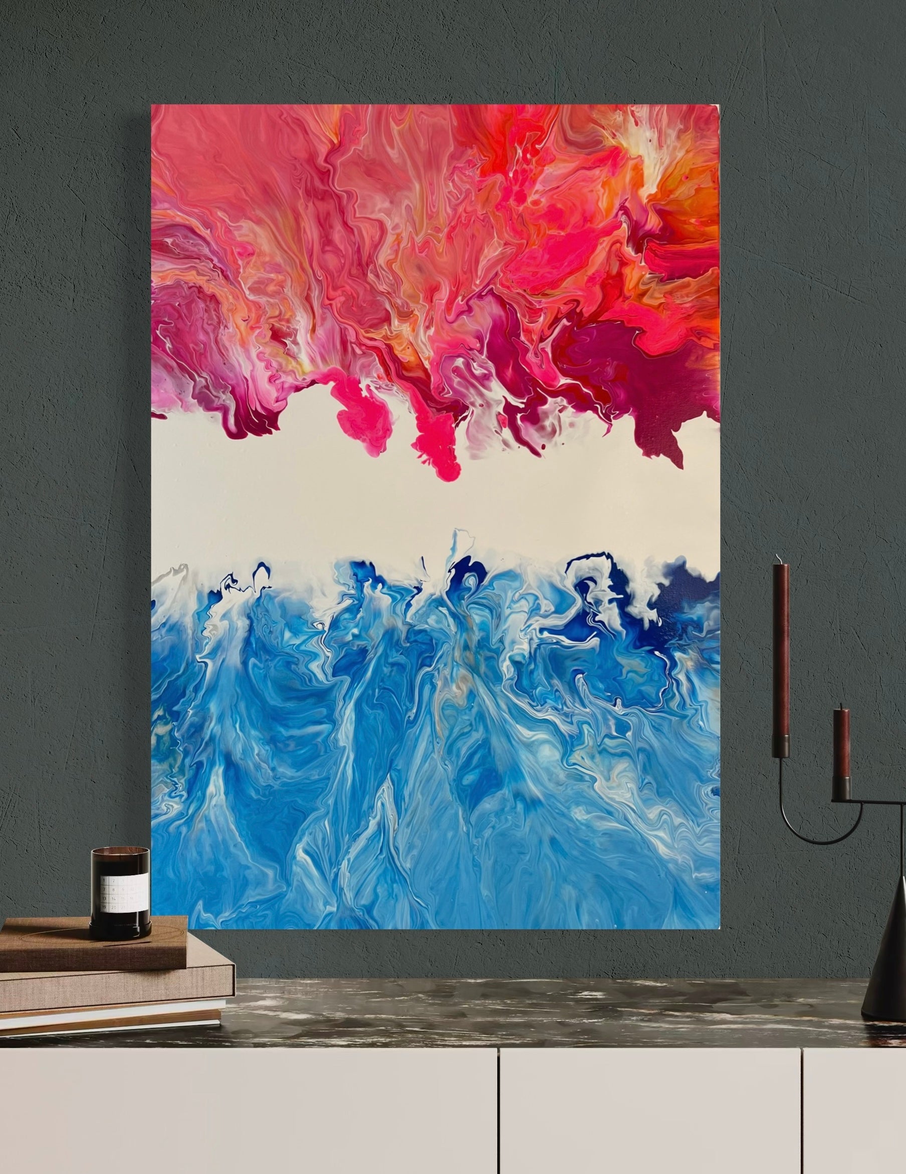 Abstract acrylic painting in vibrant shades of blue, pink, and orange, combining the dynamism of fire and water in flowing forms. The upper half of the painting features warm, fiery color gradients, while the lower blue tones are reminiscent of waves or ocean movements. Hand-painted, one-of-a-kind piece in the fluid art style—modern abstract art on canvas with strong expressiveness and harmonious color contrast, ideal as an eye-catcher in contemporary spaces.